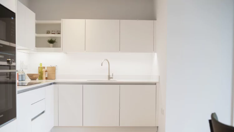 Modern white contemporary corner kitchen in an apartment at The Dials.