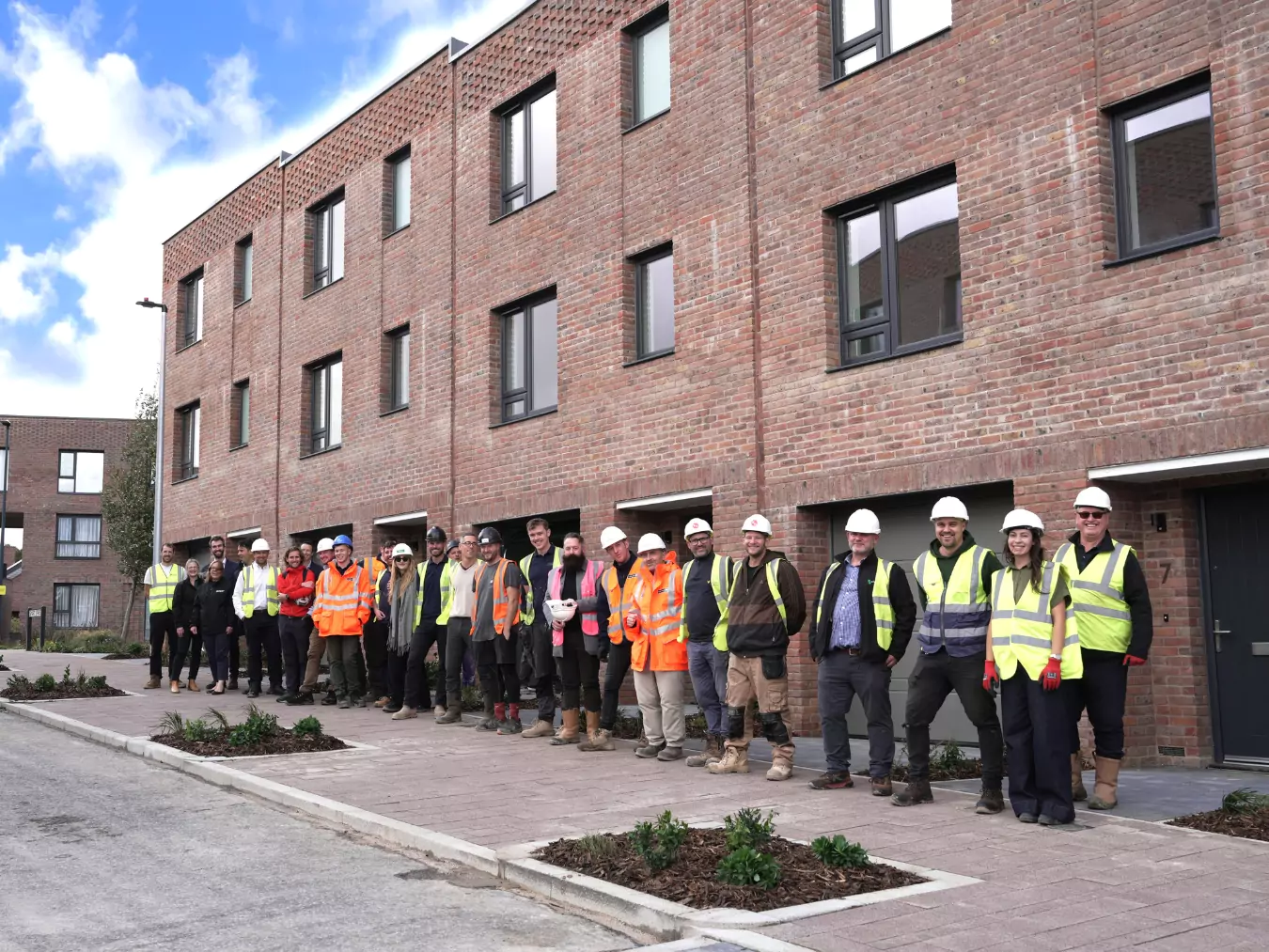 YTL Developments, YTL Construction and SNG stand outside affordable housing on Smart Street at Brabazon in North Bristol. 