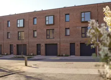 Street view of modern, 3-storey brick terrace houses at Brabazon.