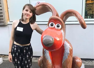 Artist Hannah Bone standing with 'Rockin Robin' Gromit Sculpture from Gromit Unleashed 2 art trail in 2018. 