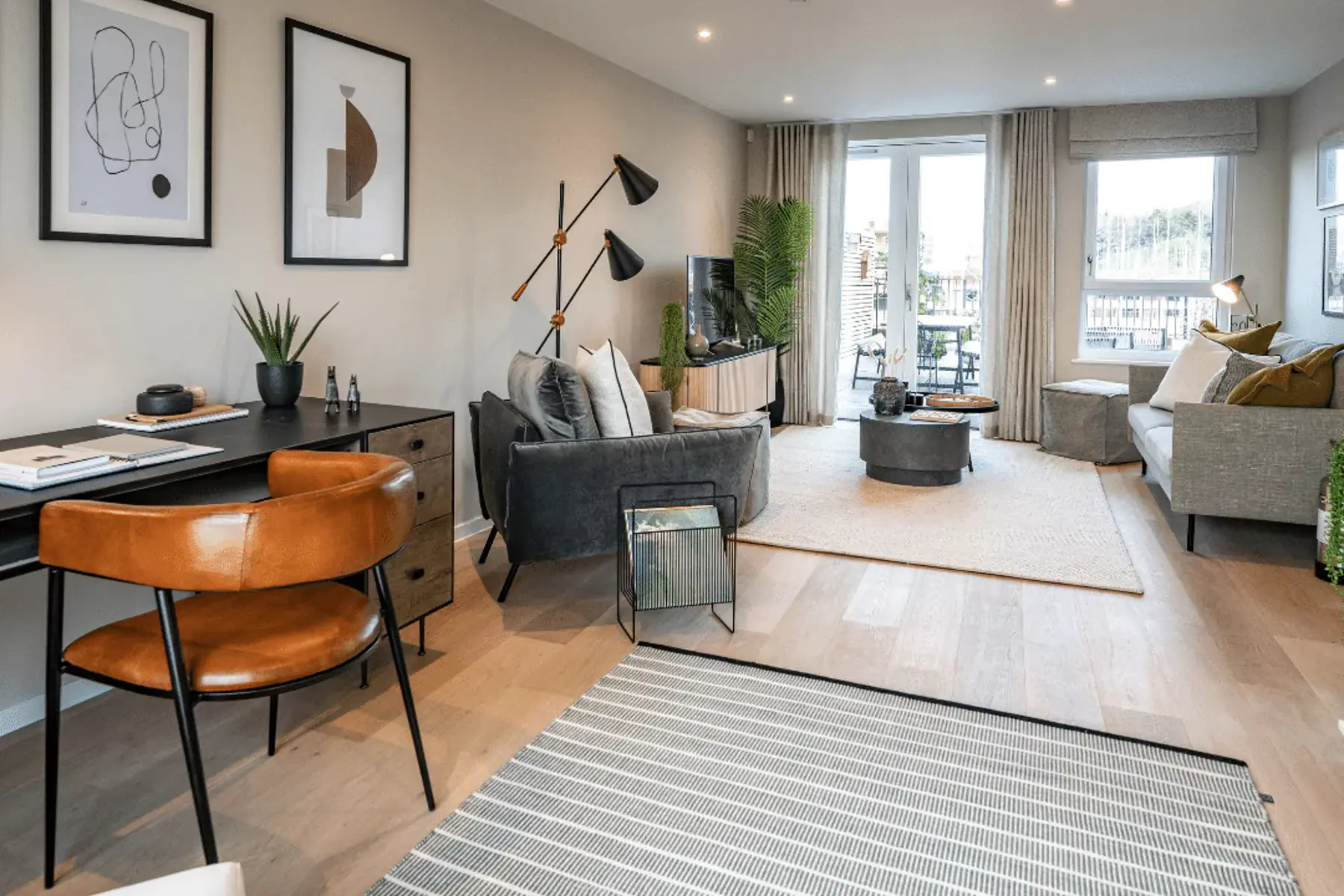 Open-plan living room flooded with natural light leading in from the terrace.