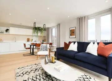 Open-plan living space flooded with natural light leading in from the terrace and large windows.