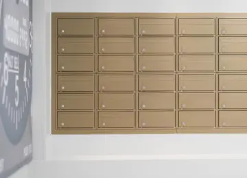 A close up of the apartment letterboxes which are gold in colour.