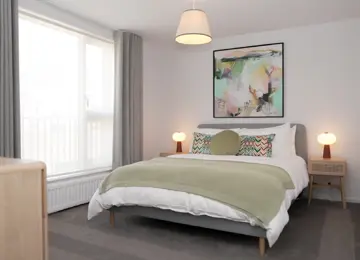 Large bedroom, with white double bed with green cushions and a light green blanket, side tables and abstract artwork on the wall. 