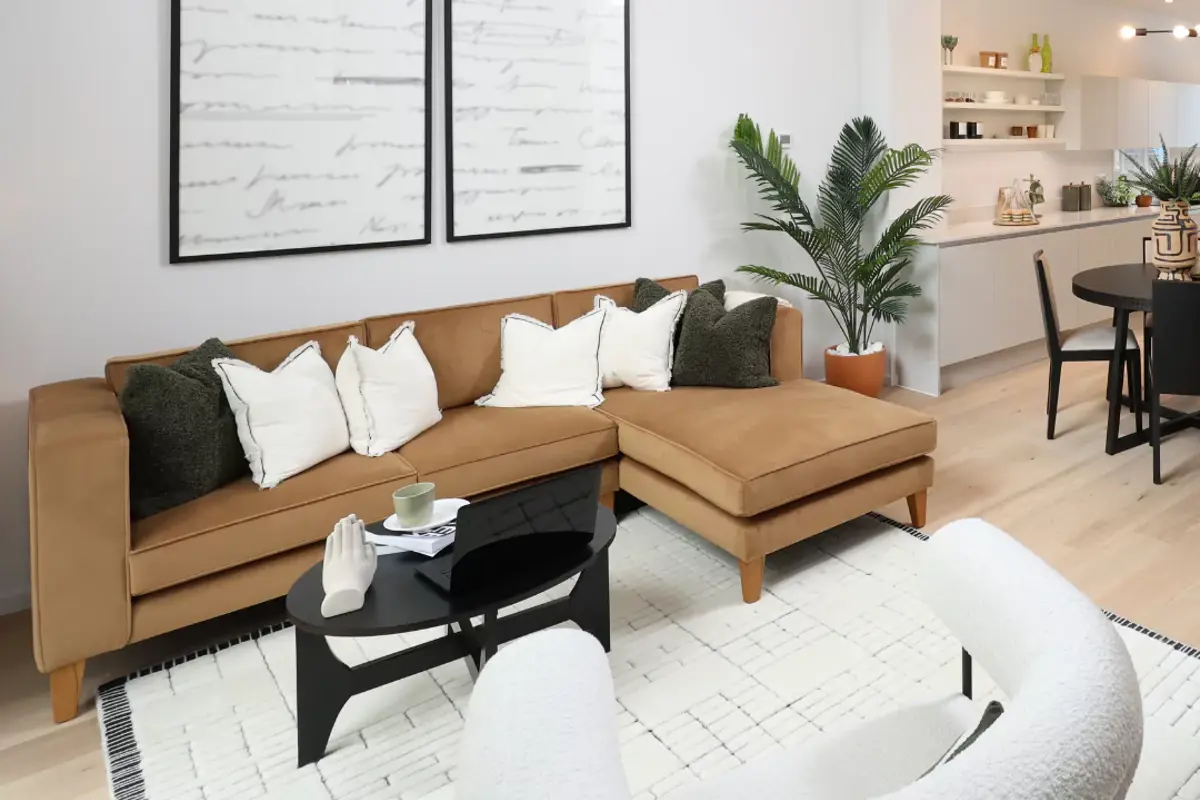 Living area featuring a styled corner sofa with cosy furnishings.