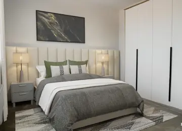Stylish master bedroom featuring a plush double bed, decorative pillows, side table lamps, and a fitted wardrobe. 
