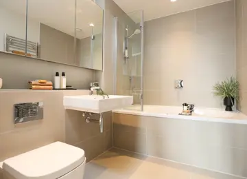 Apartment ensuite bathroom with plants and styled with a neutral tone in mind.