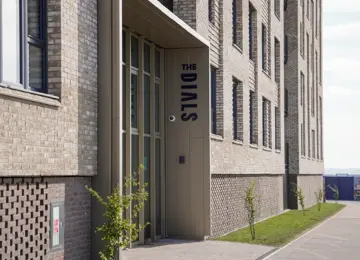 Main entrance of a modern, brick apartment building at Brabazon, Bristol 